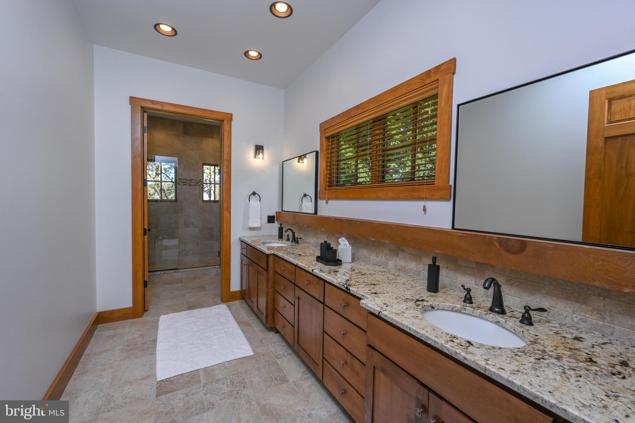 3135 Turkey Neck Road Swanton, MD 21561 - Photo 61 of 74 a bathroom with a granite countertop double vanity sink and a mirror