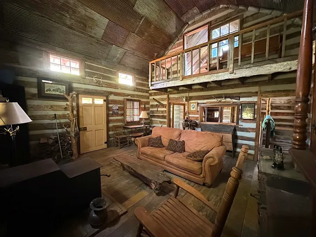 a view of water heater room with wooden floor