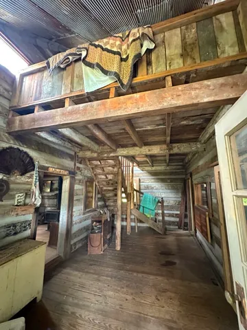 a view of a room with wooden floors and furniture