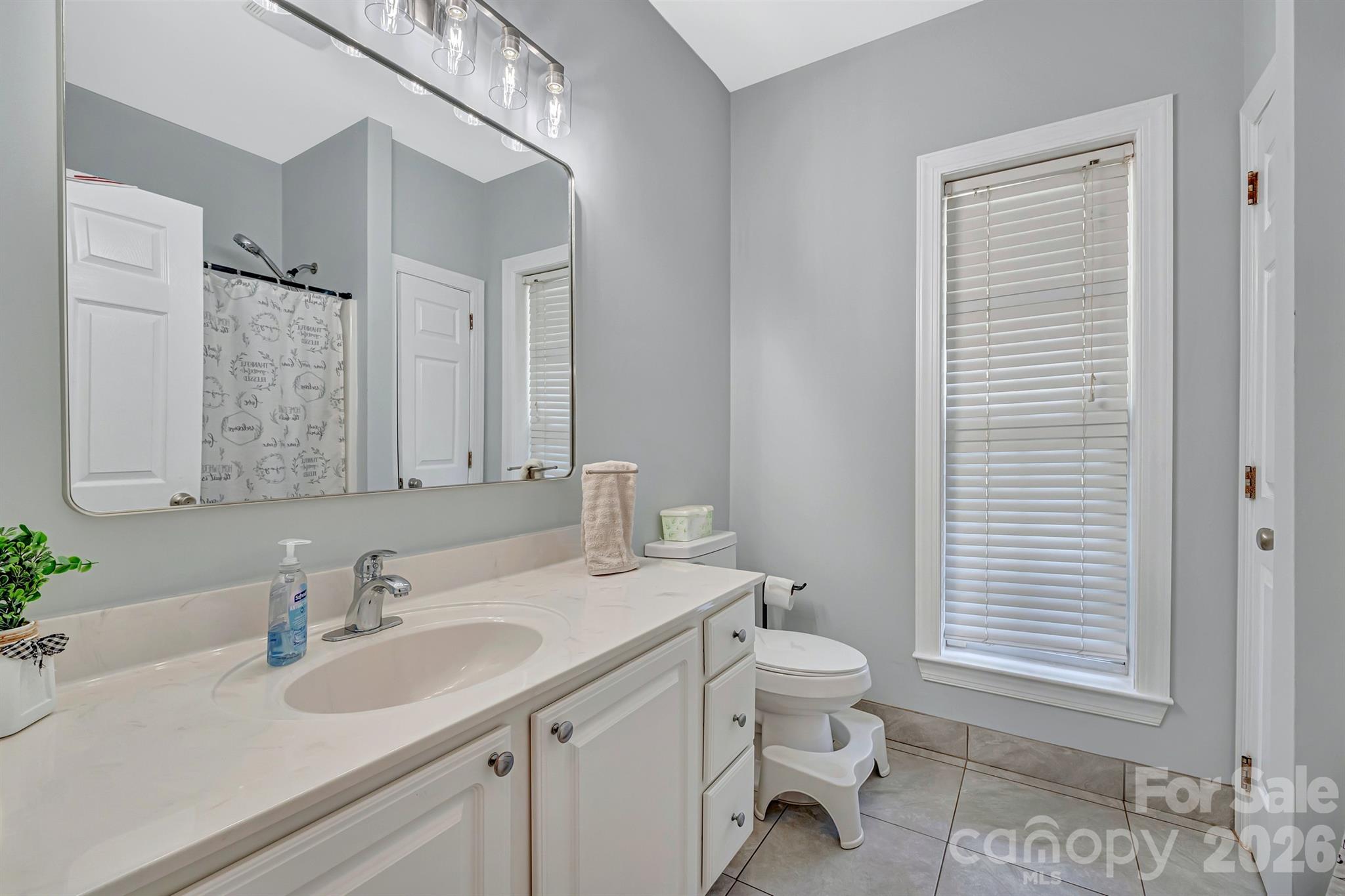 2538 Southside Road Lincolnton, NC 28092 - Photo 23 of 33 a bathroom with a granite countertop sink a toilet and a mirror
