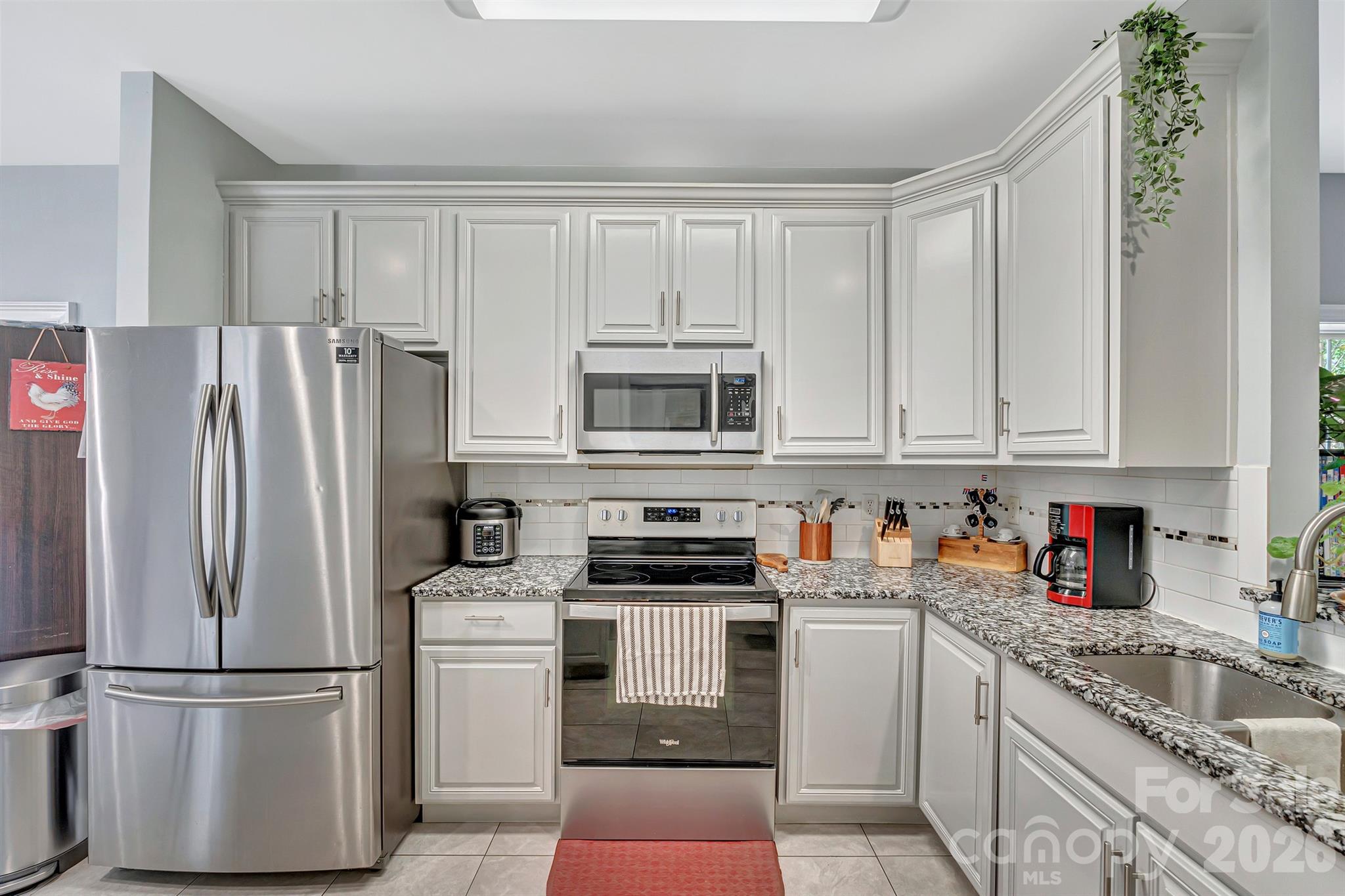 2538 Southside Road Lincolnton, NC 28092 - Photo 5 of 33 a kitchen with stainless steel appliances granite countertop a refrigerator stove and white cabinets