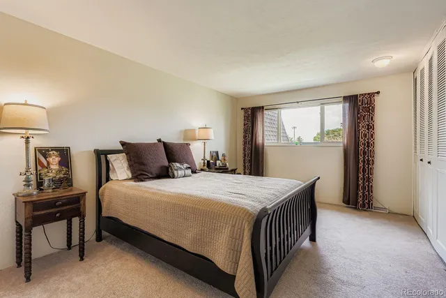a bedroom with a bed and a lamp on table