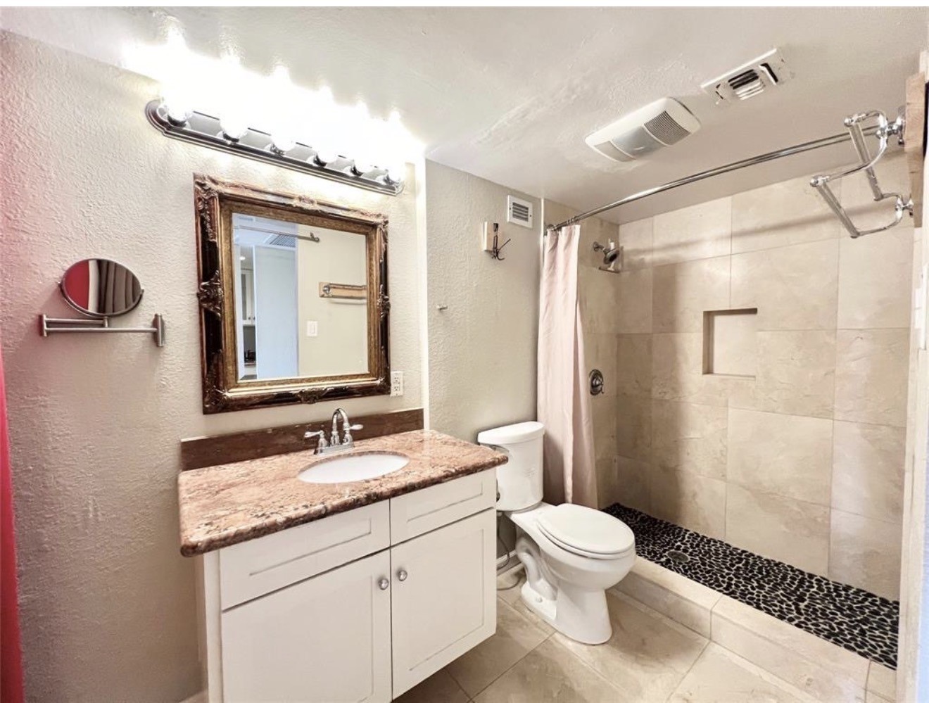 2016 Main Street, Unit 1708 Houston, TX 77002 - Photo 10 of 10 a bathroom with a granite countertop sink toilet a mirror a vanity and shower