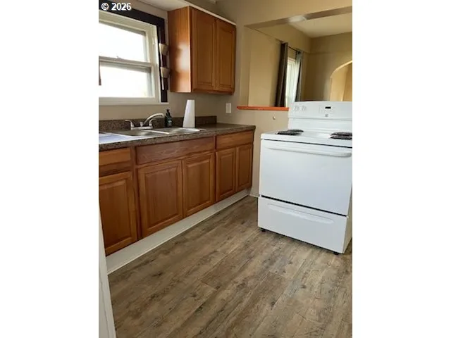 a kitchen with a sink cabinets and window