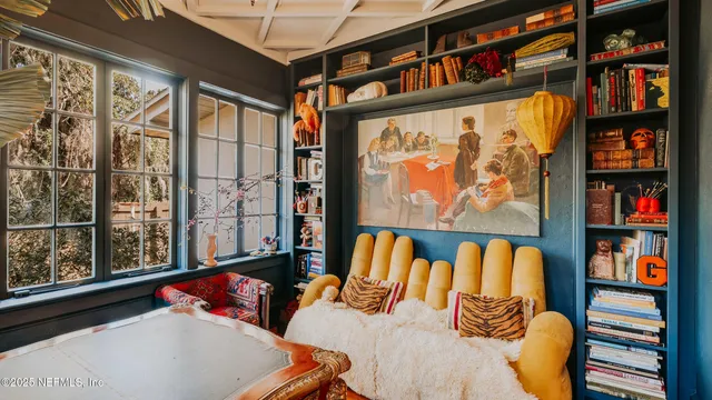 a bedroom with furniture and a book shelf