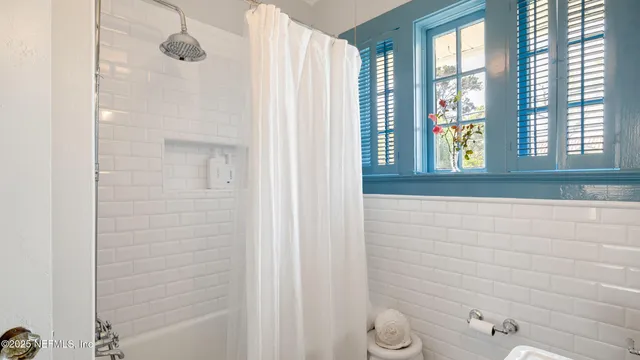 a bathroom with a shower and a bathtub