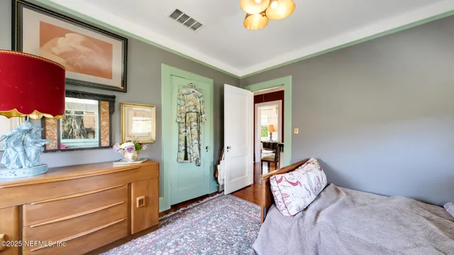 a bedroom with a bed and large windows