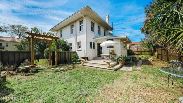a front view of a house with swimming pool and sitting area