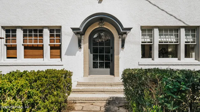 a view of a house with potted plants