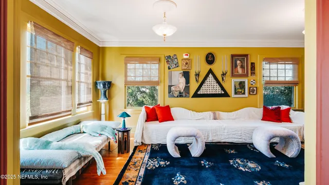 a bedroom with furniture and a large window