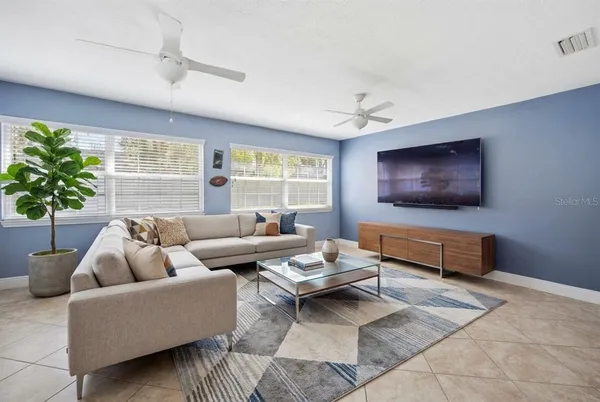 a living room with furniture and a flat screen tv