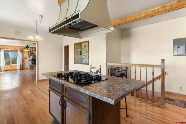 a view of a room with wooden floor and a window