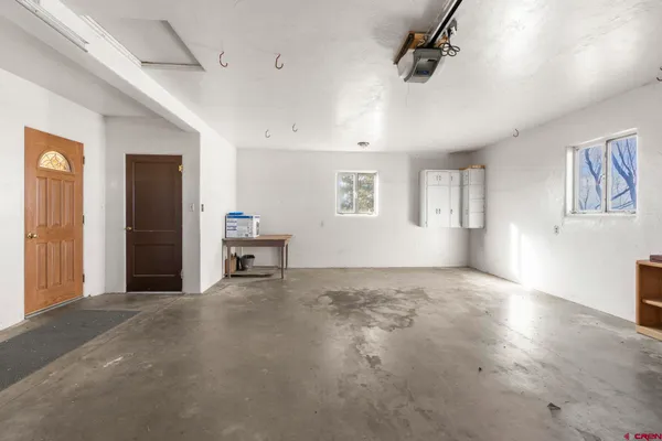 an empty room with closet and windows