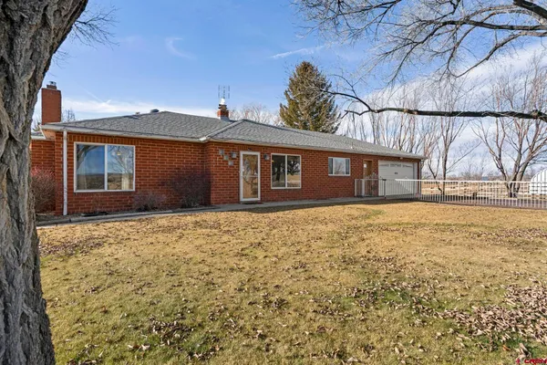 a view of swimming pool with trees and wooden fence