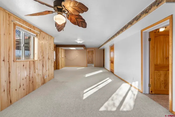 a view of an empty room with a ceiling fan