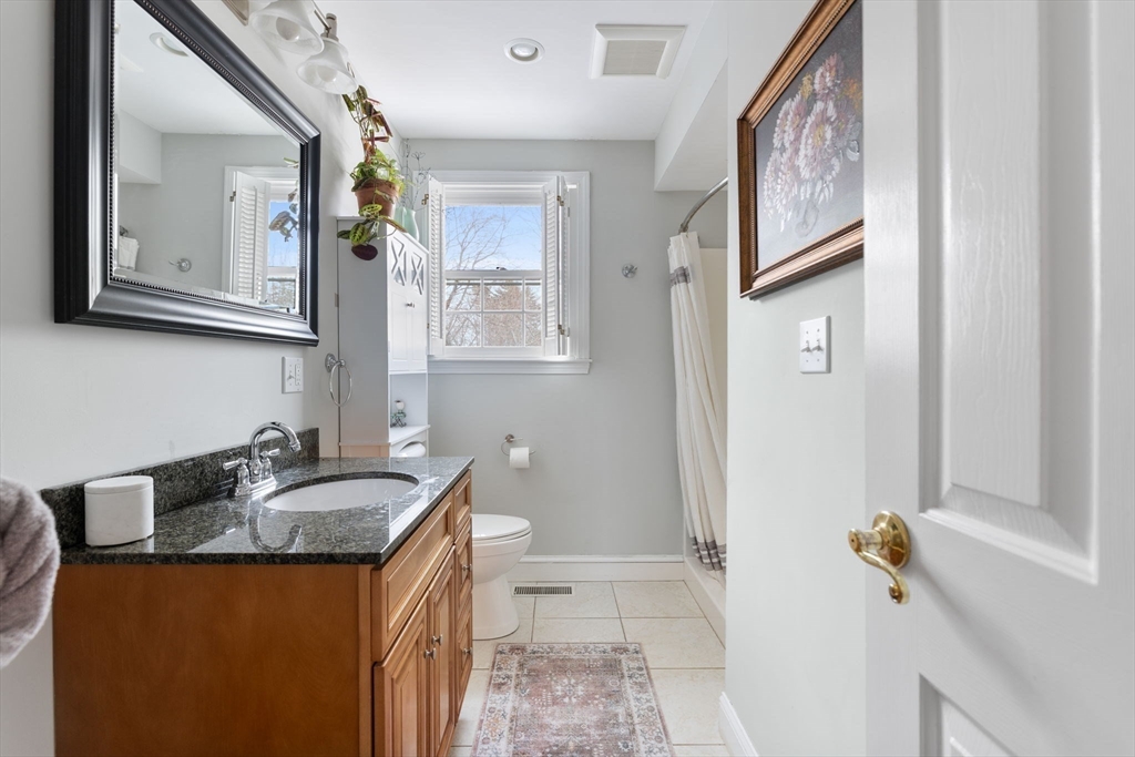 3 Independence Circle Beverly, MA 01915 - Photo 11 of 31 a bathroom with a granite countertop sink a mirror and a shower