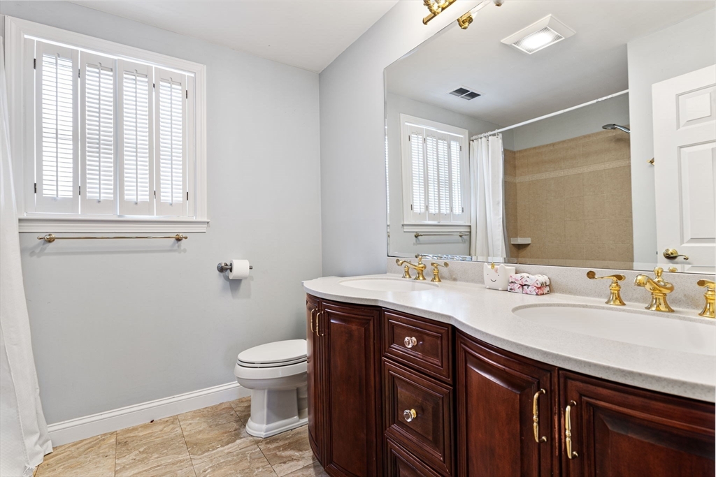 3 Independence Circle Beverly, MA 01915 - Photo 16 of 31 a bathroom with a toilet a sink a mirror a window and vanity