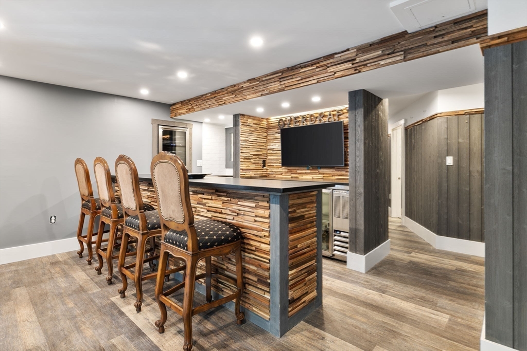 3 Independence Circle Beverly, MA 01915 - Photo 24 of 31 a view of a kitchen with stainless steel appliances kitchen island granite countertop a table and chairs