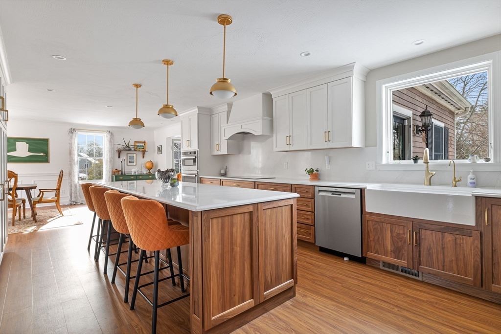 3 Independence Circle Beverly, MA 01915 - Photo 4 of 31 a kitchen with stainless steel appliances granite countertop a sink a stove a refrigerator and island with wooden floor