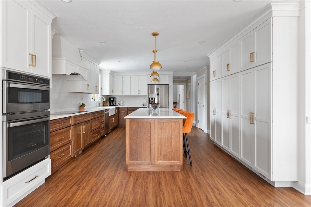 3 Independence Circle Beverly, MA 01915 - Photo 6 of 31 a kitchen with kitchen island wooden floors appliances and center island