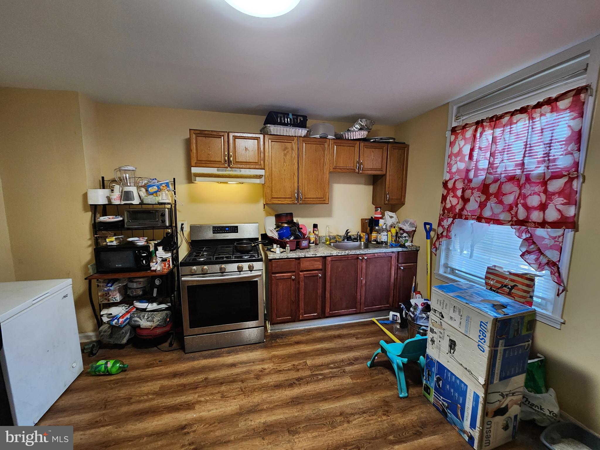 3017 Erdman Avenue Baltimore, MD 21213 - Photo 7 of 13 a kitchen with stainless steel appliances granite countertop a stove and a refrigerator