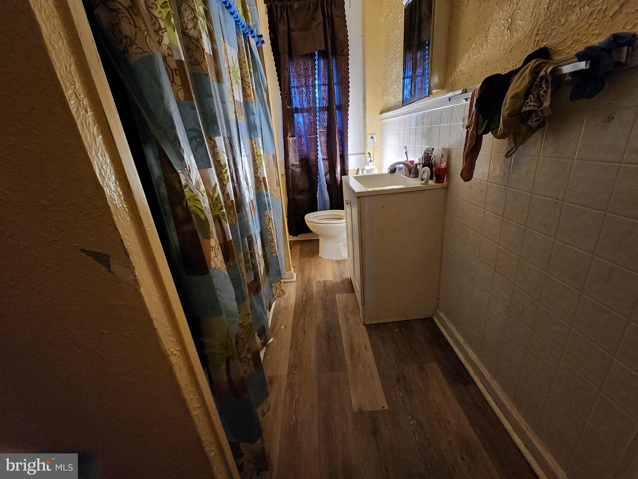 3017 Erdman Avenue Baltimore, MD 21213 - Photo 10 of 13 a view of a closet with wooden floor