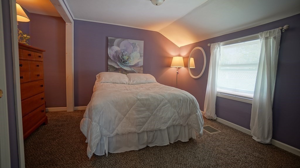 245 Fair Oak Road Springfield, MA 01128 - Photo 14 of 37 a bed sitting in a bedroom next to a window
