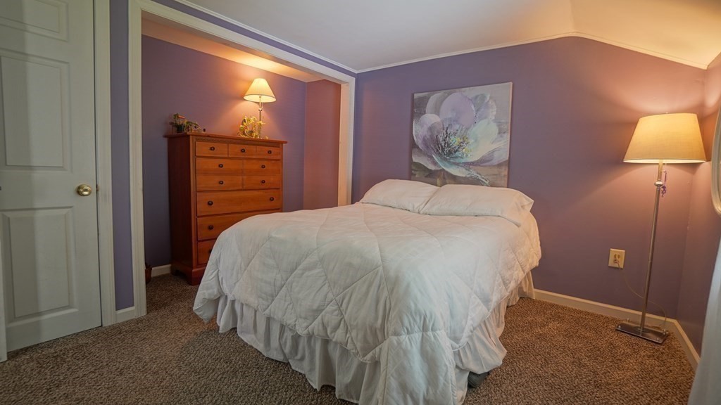 245 Fair Oak Road Springfield, MA 01128 - Photo 15 of 37 a bedroom with a bed and a lamp
