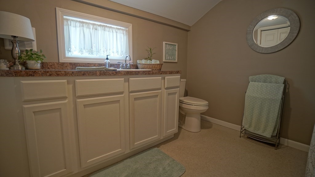 245 Fair Oak Road Springfield, MA 01128 - Photo 17 of 37 a bathroom with a sink a toilet and a mirror