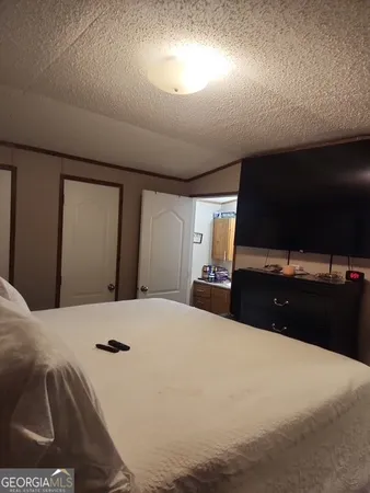 a bedroom with a large bed and a large mirror