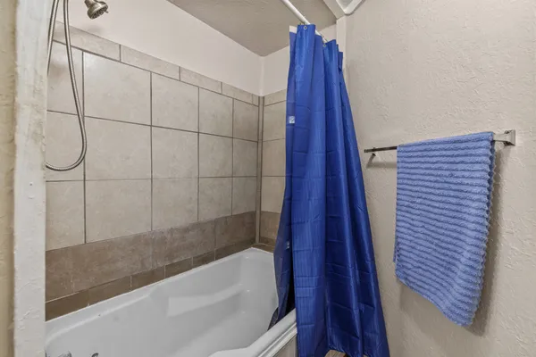 a bathroom with a bathtub and shower