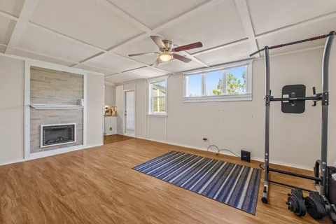 a view of an empty room with a fireplace and a window