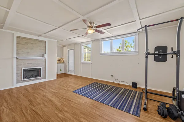 a view of an empty room with a fireplace and a window
