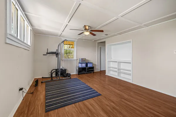 a view of a livingroom with furniture staircase and a ceiling fan