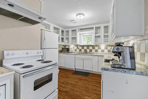 a kitchen with a stove a sink and a refrigerator