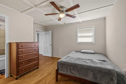 a bedroom with a bed and a dresser
