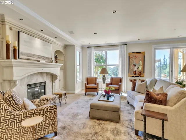 a living room with furniture fireplace and a large window