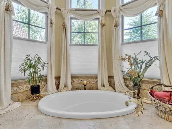 a bath tub sitting in a bathroom next to a window