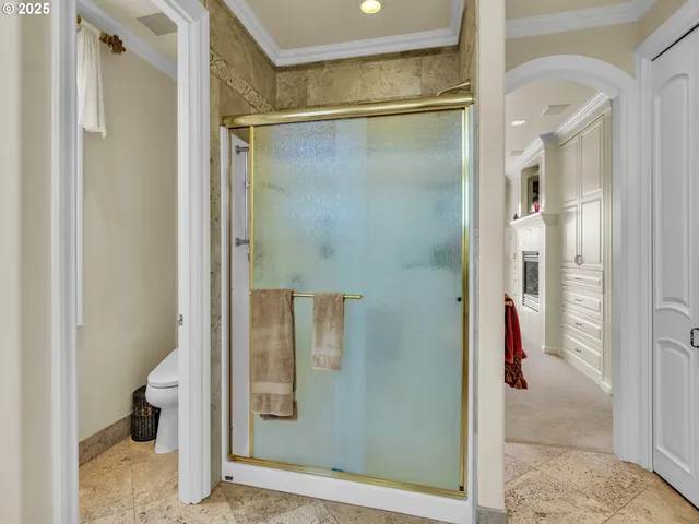 a bathroom with a glass shower door