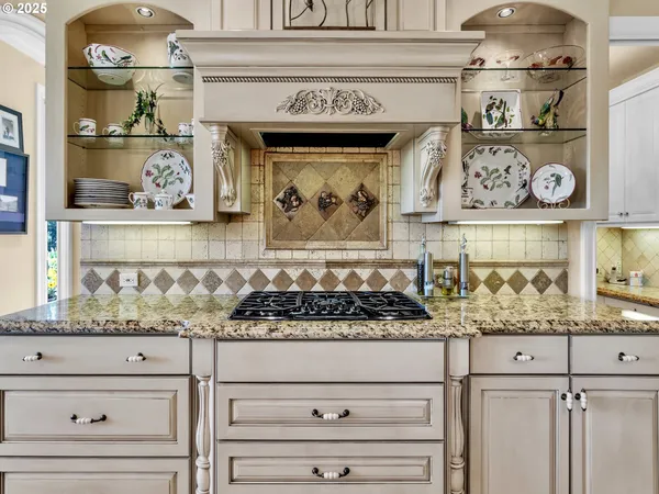 a kitchen with stove and cabinets