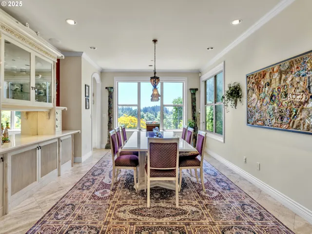 a dining room with furniture a chandelier and wooden floor