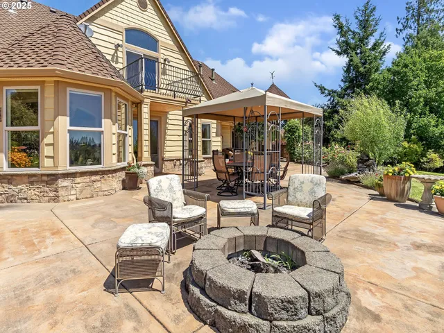 a patio with a table and chairs under an umbrella