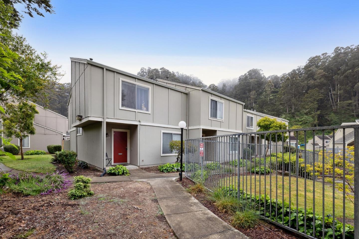 1287 Rosita Road Pacifica, CA 94044 - Photo 11 of 76 a front view of a house with a garden