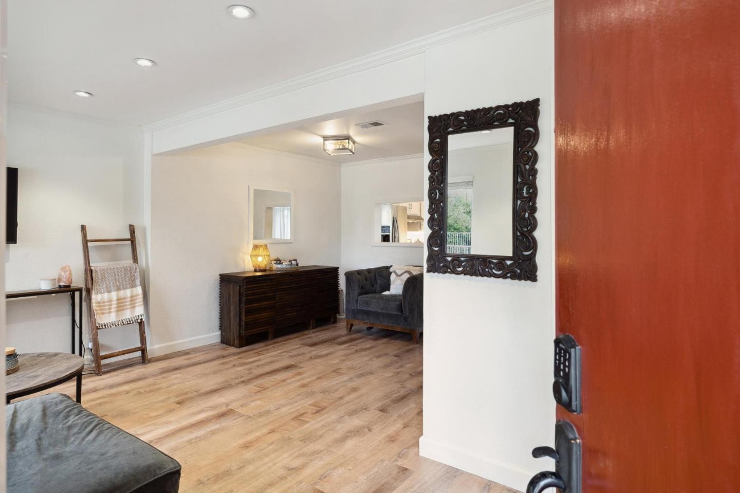 1287 Rosita Road Pacifica, CA 94044 - Photo 15 of 76 a living room with a couch and a dresser with wooden floor