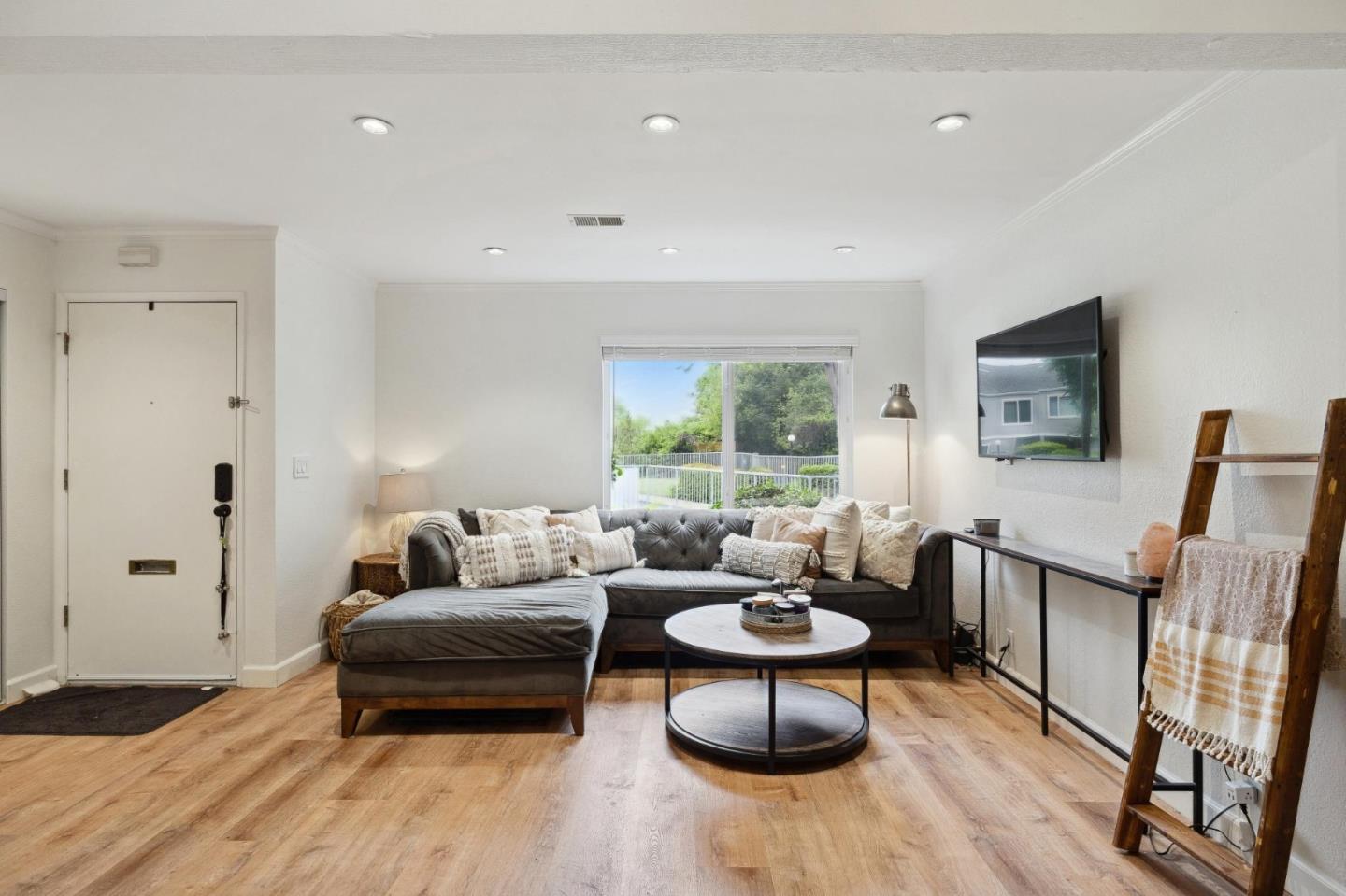 1287 Rosita Road Pacifica, CA 94044 - Photo 20 of 76 a living room with furniture a flat screen tv and a window