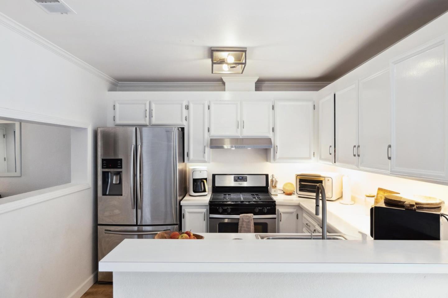1287 Rosita Road Pacifica, CA 94044 - Photo 26 of 76 a kitchen with stainless steel appliances and a refrigerator