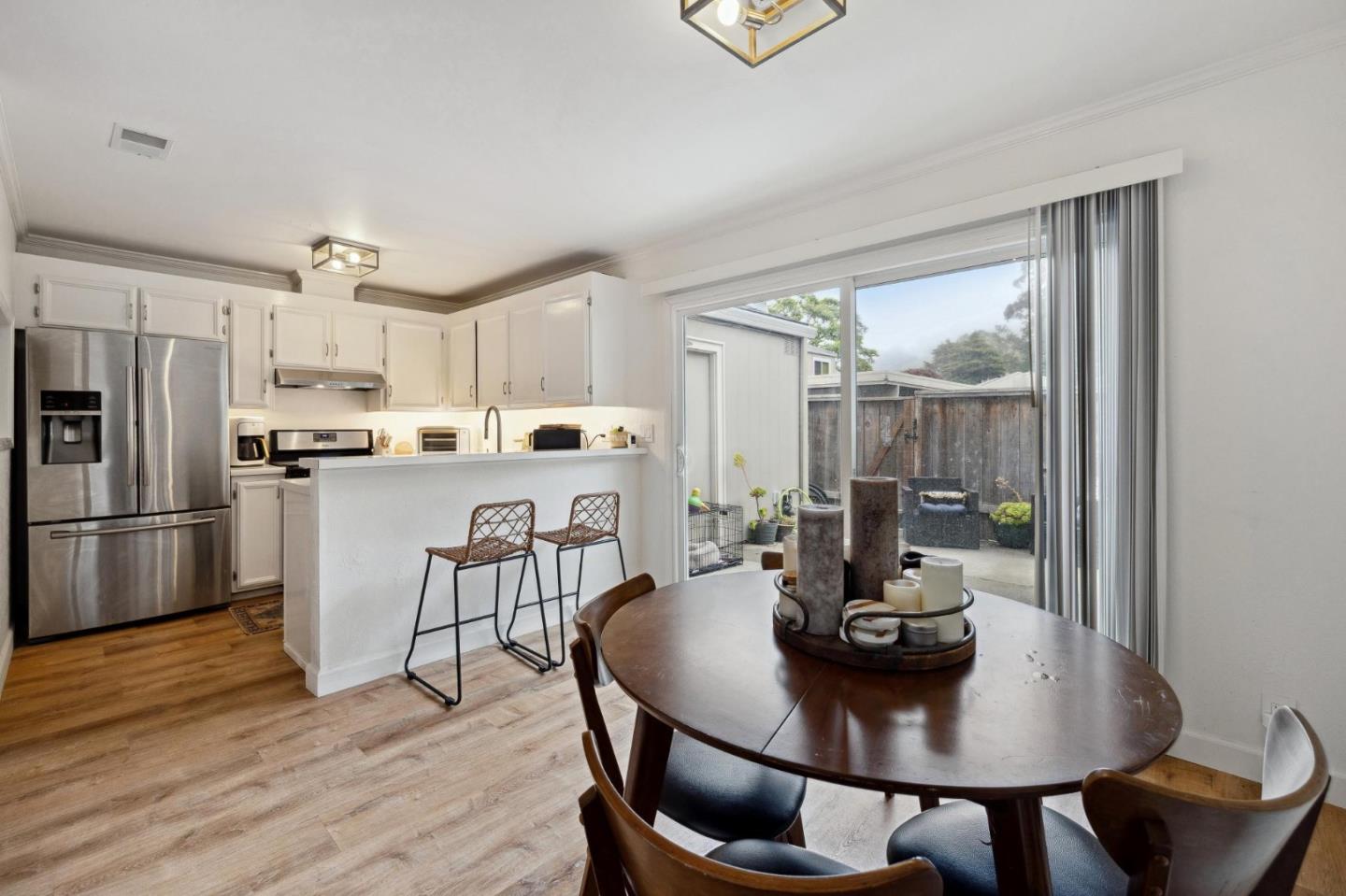1287 Rosita Road Pacifica, CA 94044 - Photo 31 of 76 a kitchen with a dining table chairs and refrigerator