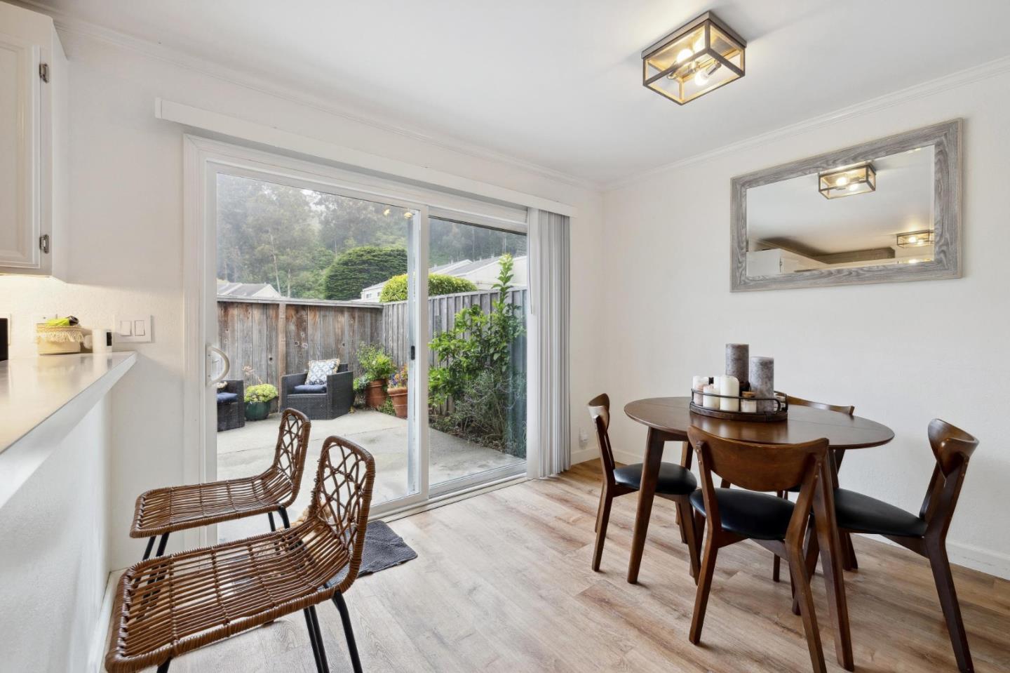 1287 Rosita Road Pacifica, CA 94044 - Photo 32 of 76 a dining room with furniture a rug and a floor to ceiling window