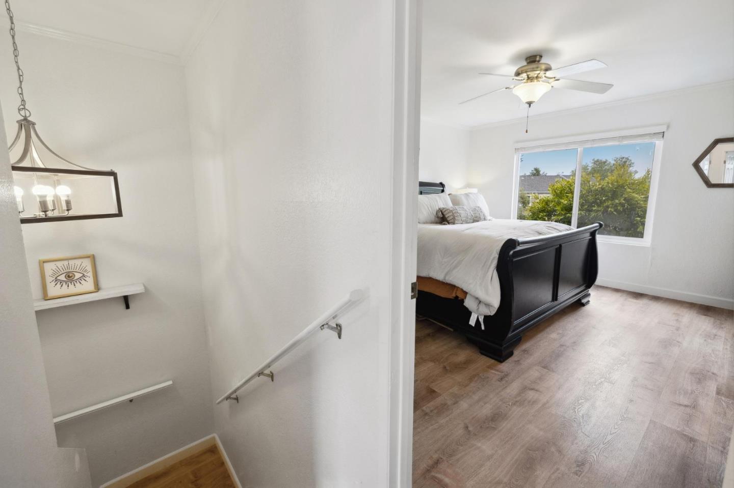 1287 Rosita Road Pacifica, CA 94044 - Photo 34 of 76 a room with a bed and a chandelier