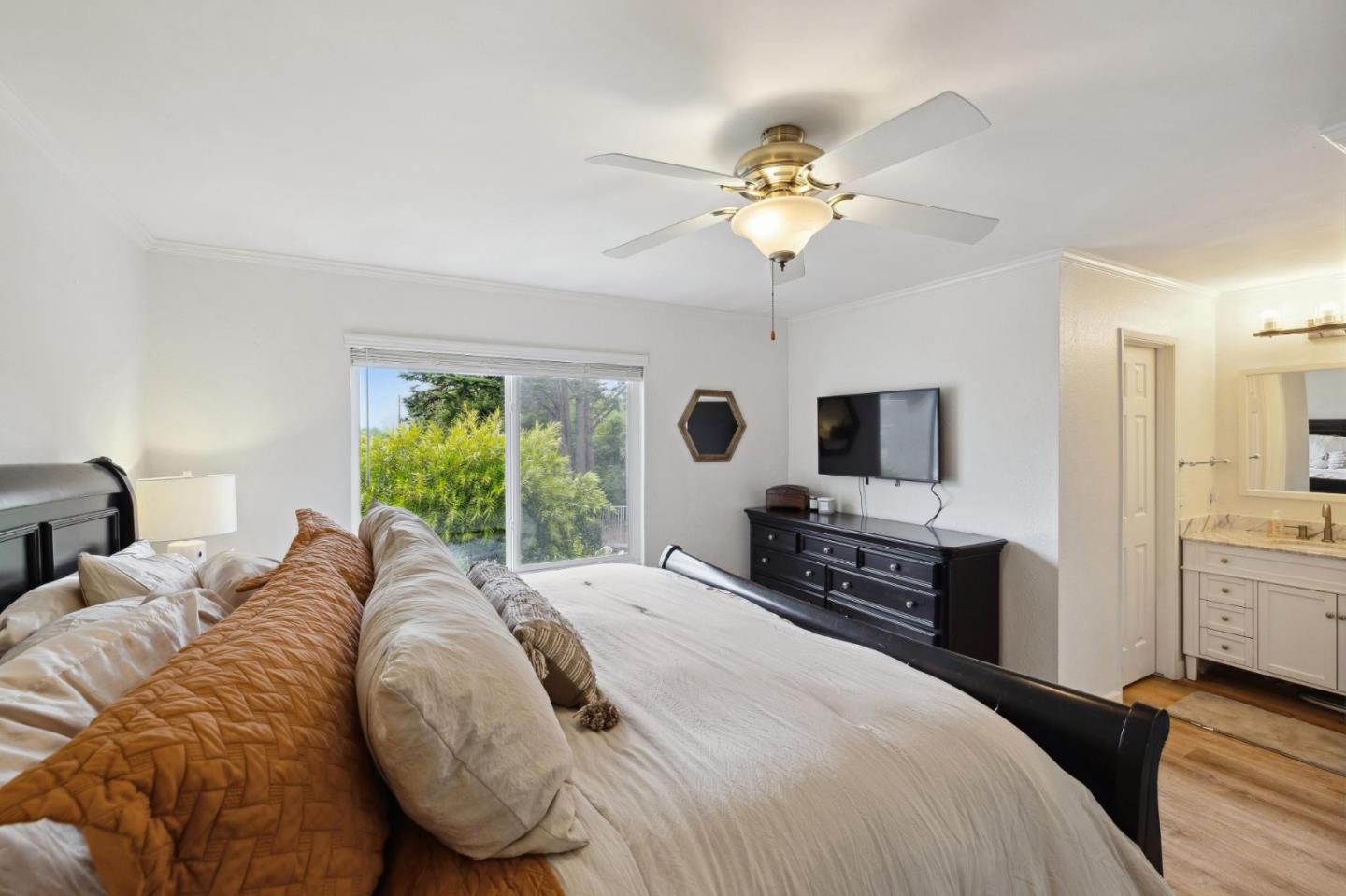 1287 Rosita Road Pacifica, CA 94044 - Photo 36 of 76 a bedroom with a large bed and a flat tv screen